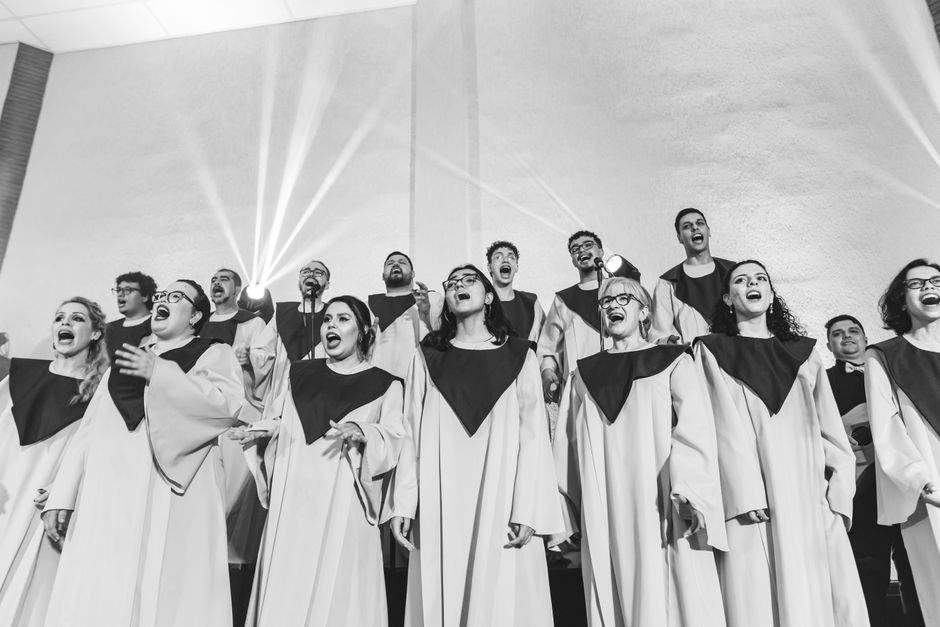A vibrant choir passionately sings together, expressing harmony and joy in black and white.